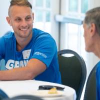 Two gentlemen sitting at table in conversation
